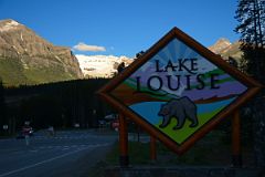 01 Welcome To Lake Louise Sign With Fairview Mountain, Mount Victoria, Mount Whyte Early Morning From Lake Louise Village.jpg